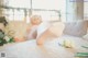 A woman laying on a bed with her feet up on a table.