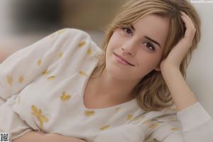 A woman in a white shirt is posing for a picture.